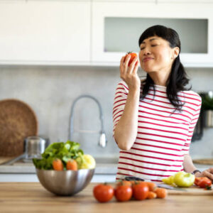 Portrait of an attractive mid adult japanese woman cooking at home
