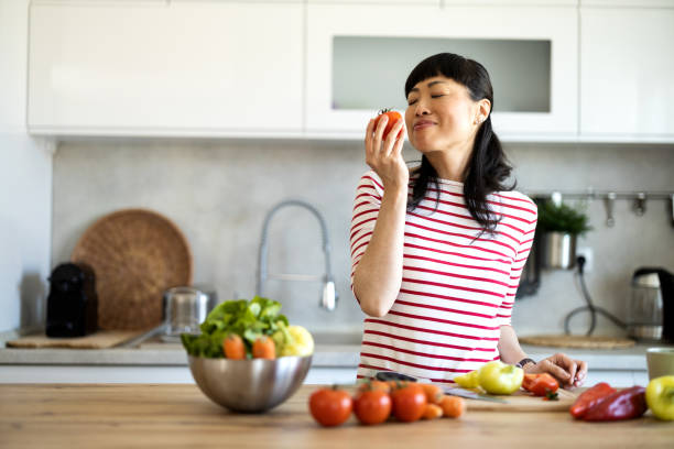 Portrait of an attractive mid adult japanese woman cooking at home